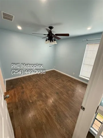 a view of a room with wooden floor