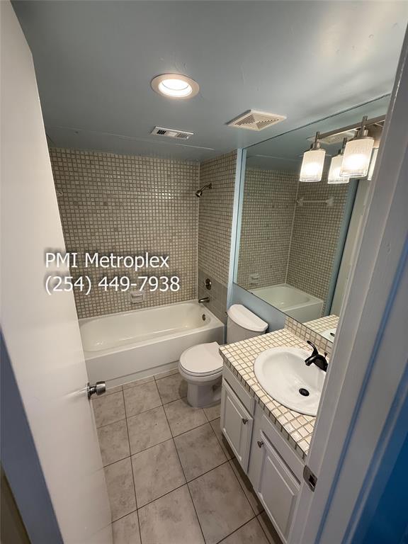 18240 Midway Road, Unit 606 Dallas, TX 75287 - Photo 6 of 25 a bathroom with a sink a toilet and shower
