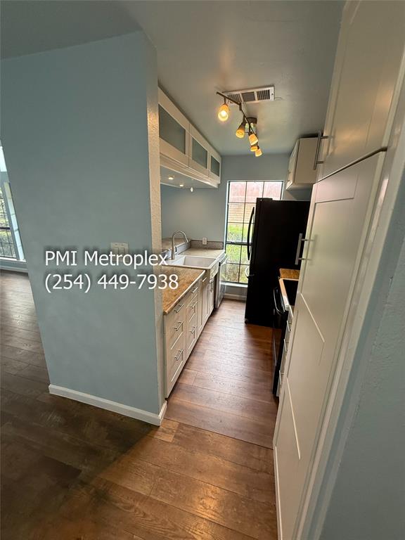 18240 Midway Road, Unit 606 Dallas, TX 75287 - Photo 9 of 25 a view of a hallway with wooden floor and staircase