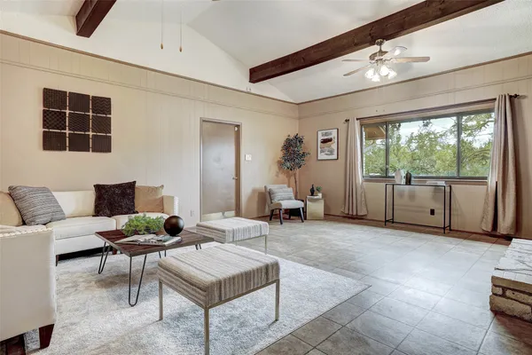 a living room with furniture and a large window