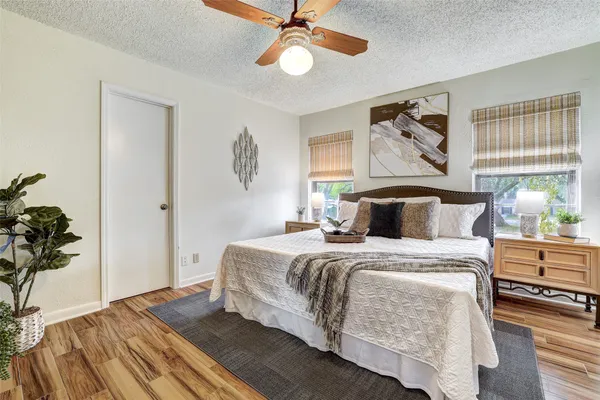 a bedroom with bed and wooden floor
