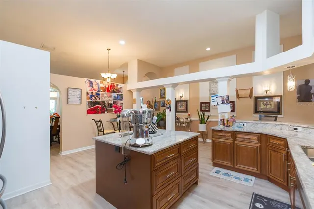 a view of a dining room with furniture and chandelier