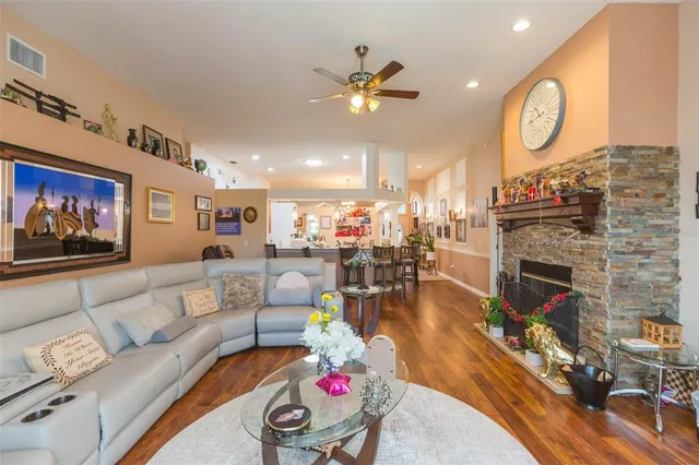 a living room with fireplace furniture and a flat screen tv