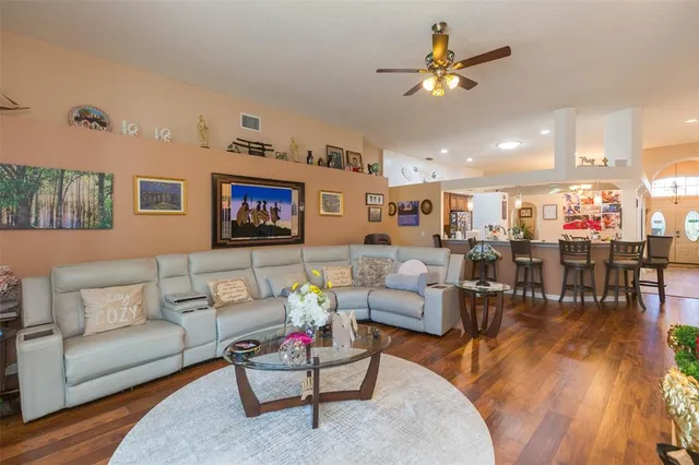 a bedroom with a bed dresser and wooden floor
