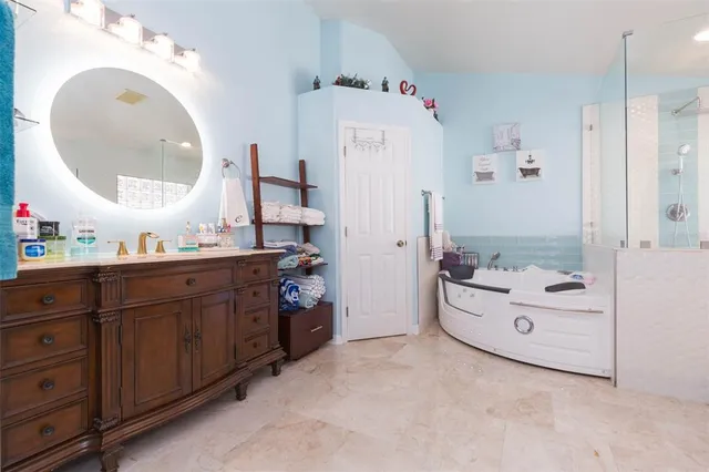 a bathroom with a sink a toilet and a large mirror
