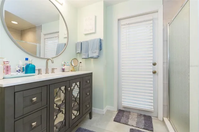 a bedroom with a bed a flat screen tv and a chandelier