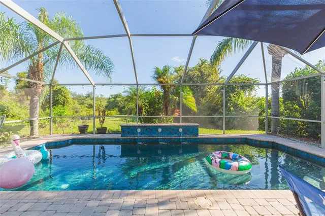 a backyard of a house with lots of green space and trees all around