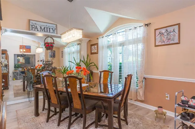 a kitchen with stainless steel appliances kitchen island granite countertop a refrigerator a stove and a sink with cabinets