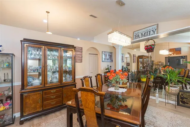 a kitchen with sink a refrigerator and wooden cabinets