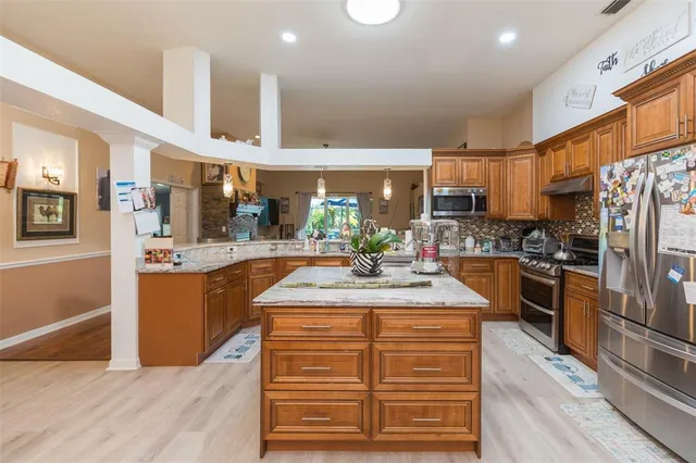 a view of a dining room with furniture and a large window