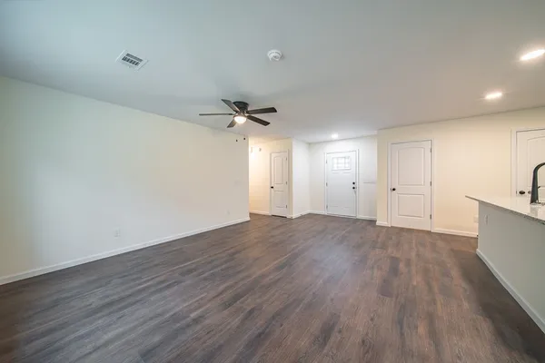 a view of an empty room and wooden floor