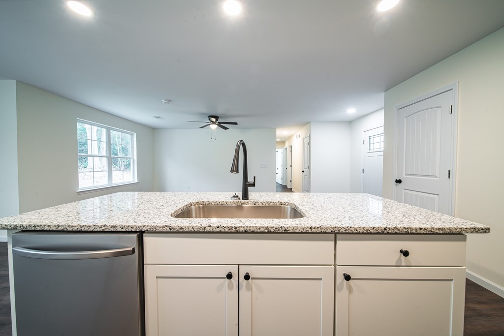 4390 Forrest Road Columbus, GA 31907 - Photo 10 of 26 a bathroom with a granite countertop sink and white cabinets