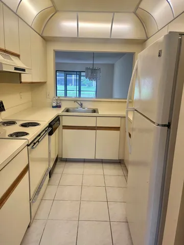a kitchen with stainless steel appliances granite countertop a sink and cabinets