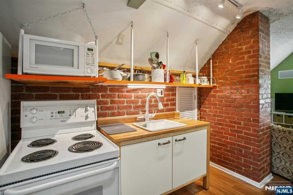 16 Henry Street, Unit 3 Bloomfield, NJ 07003 - Photo 11 of 21 a bathroom with a sink and a stove