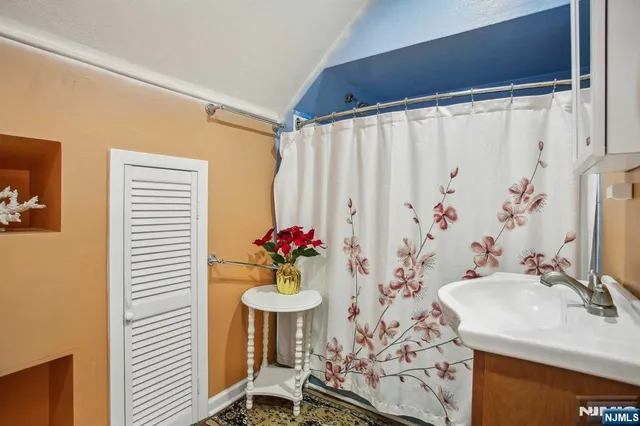 a balcony with a bench and white walls