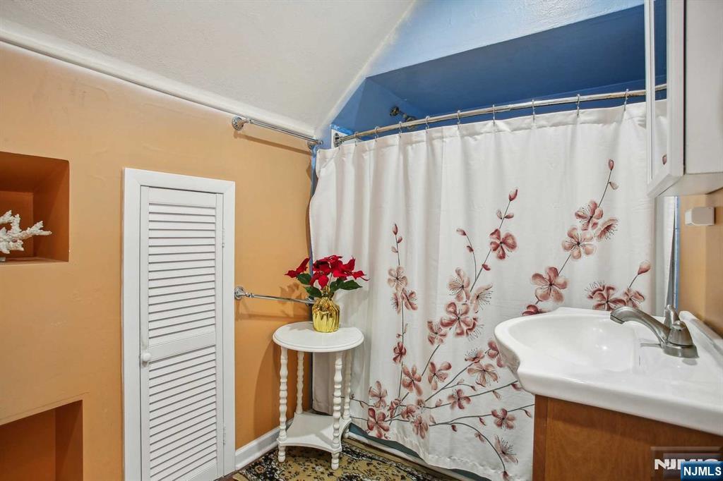 16 Henry Street, Unit 3 Bloomfield, NJ 07003 - Photo 16 of 21 a bathroom with a sink and a mirror