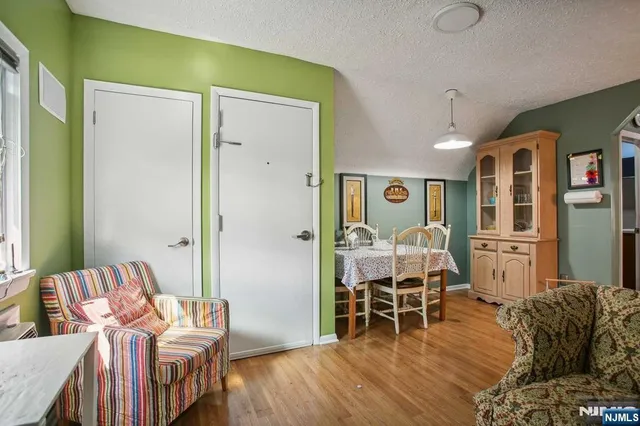 a view of kitchen with stainless steel appliances granite countertop a stove and a microwave