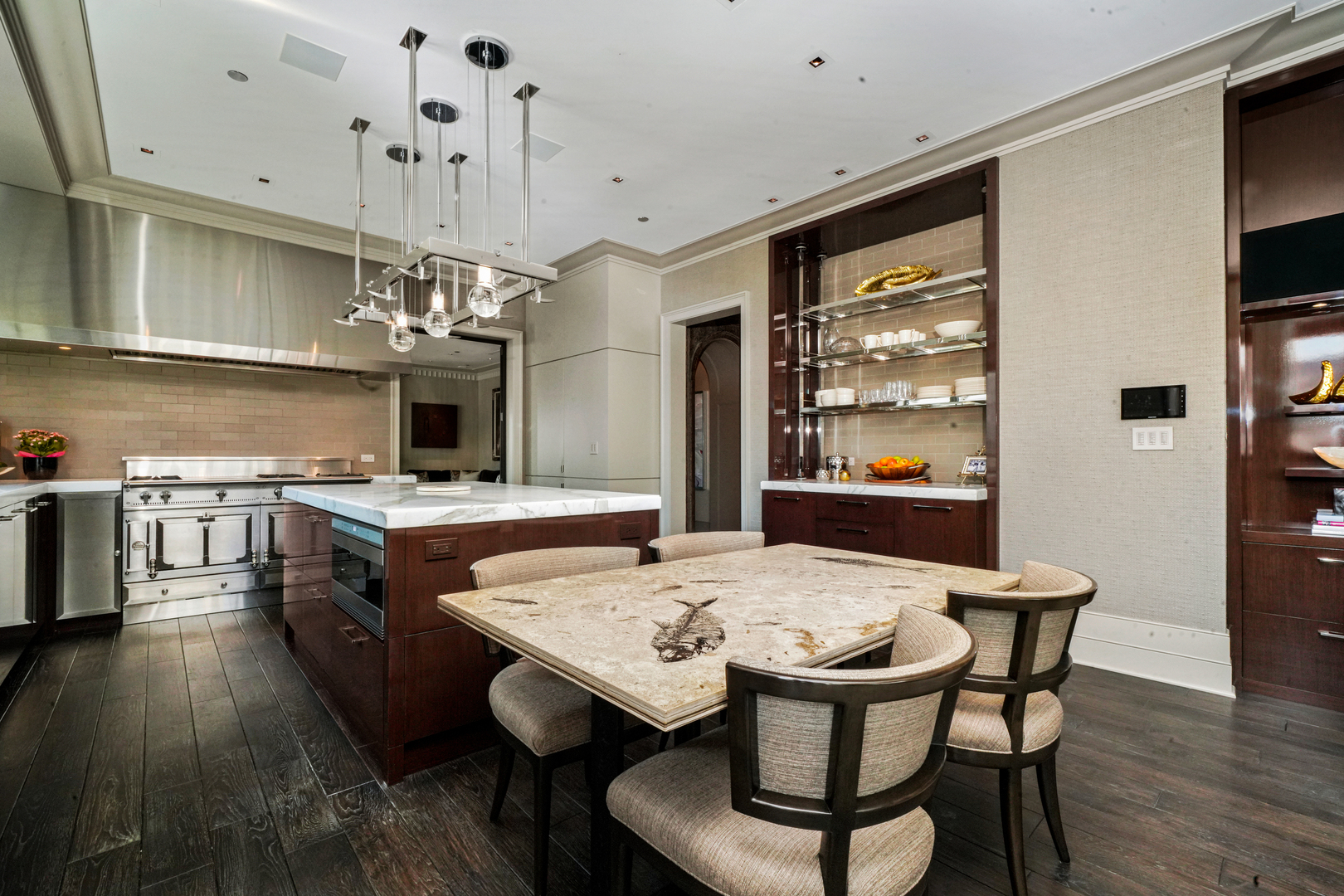 10 East Delaware Place, Unit 34A Chicago, IL 60611 - Photo 2 of 51 a kitchen with stainless steel appliances kitchen island granite countertop a table chairs sink and cabinets