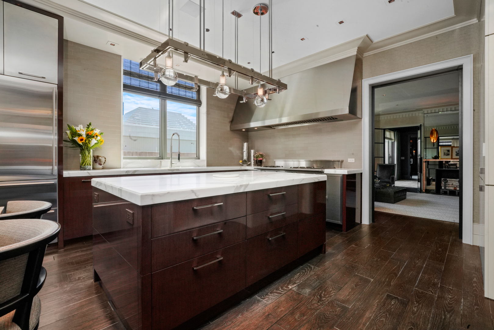 10 East Delaware Place, Unit 34A Chicago, IL 60611 - Photo 3 of 51 a kitchen with a sink cabinets and wooden floor