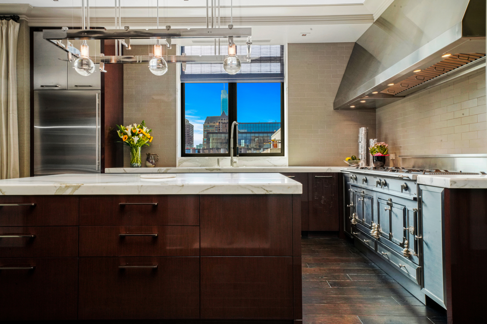 10 East Delaware Place, Unit 34A Chicago, IL 60611 - Photo 4 of 51 a kitchen with a sink and a refrigerator