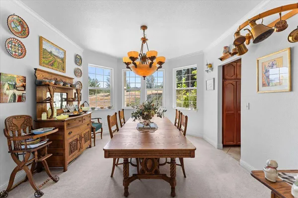 a view of a dining room with furniture and chandelier