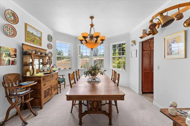 a view of a dining room with furniture and chandelier