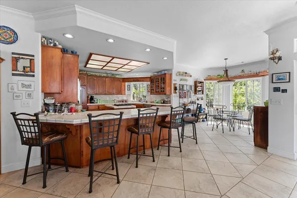 a kitchen with stainless steel appliances granite countertop a stove top oven a sink dishwasher and cabinets with wooden floor