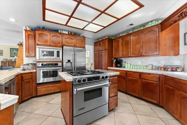 a kitchen with stainless steel appliances granite countertop a sink and cabinets