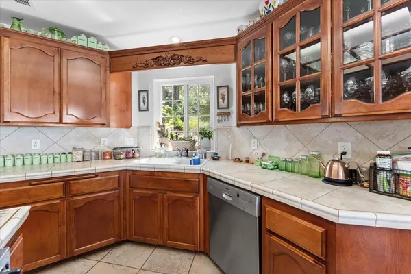 a kitchen with a sink stove and cabinets