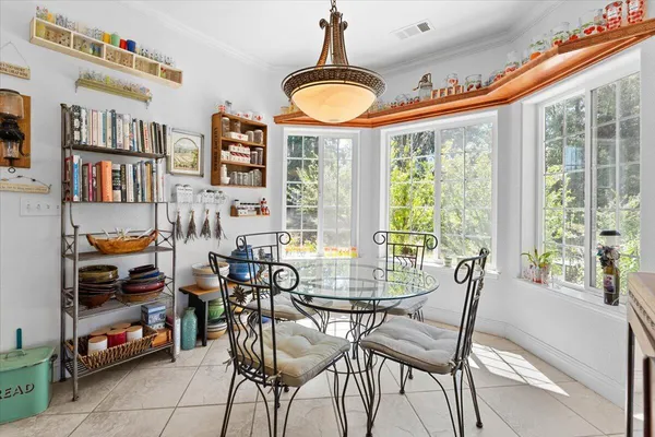 a living room with furniture a fireplace and a large window