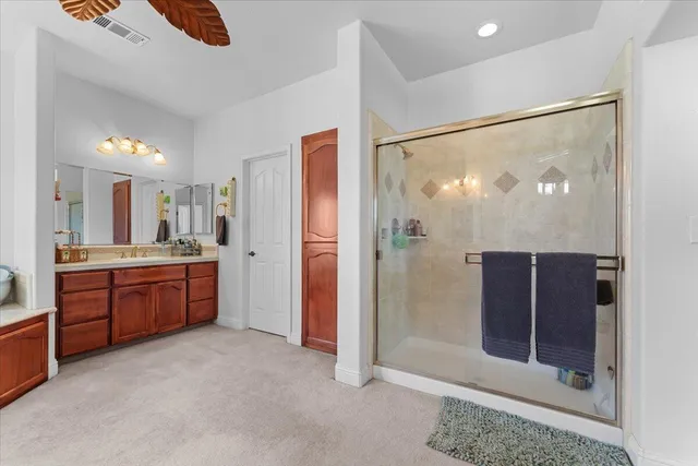 a bedroom with a bed a mirror and a window