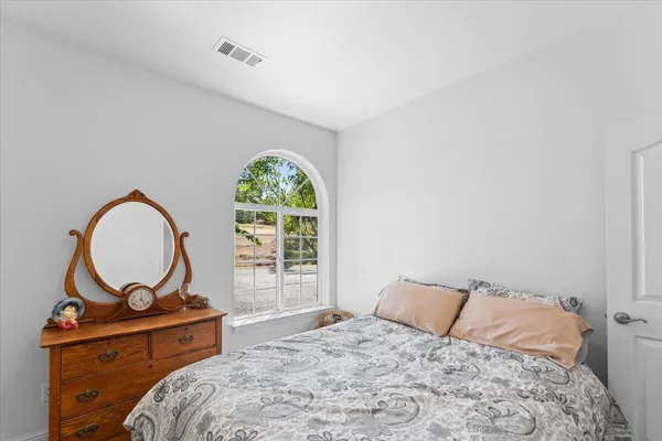 a bedroom with a bed and a painting on the wall