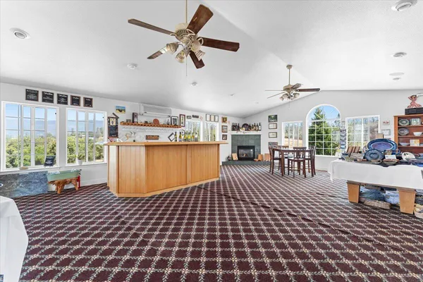 a living room with furniture a fireplace and a large window