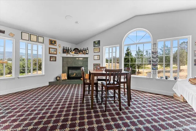 an aerial view of residential houses with outdoor space and trees