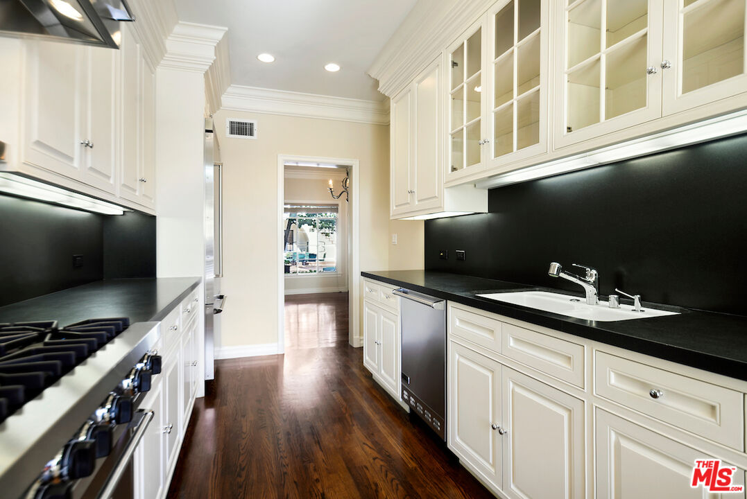157 South Rodeo Drive Beverly Hills, CA 90212 - Photo 4 of 7 a kitchen with a sink and cabinets