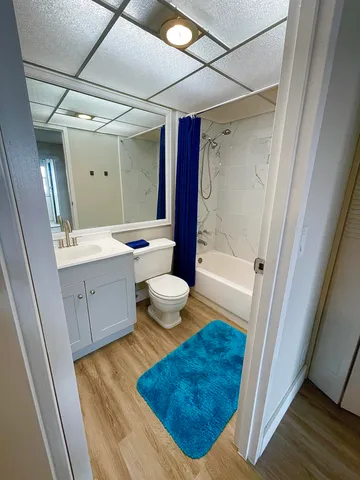 a bathroom with a sink toilet a mirror and shower