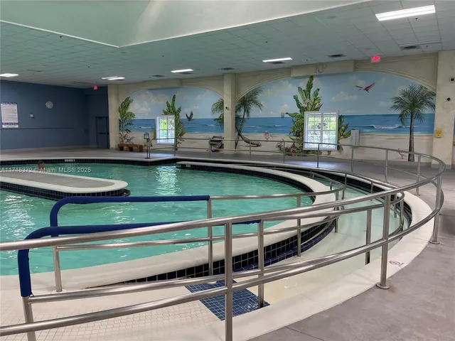 a kitchen with counter top space and windows