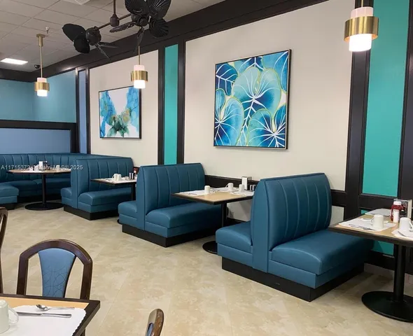 a living room with furniture ceiling fan and a window