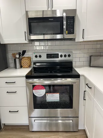 a stove top oven sitting inside of a kitchen