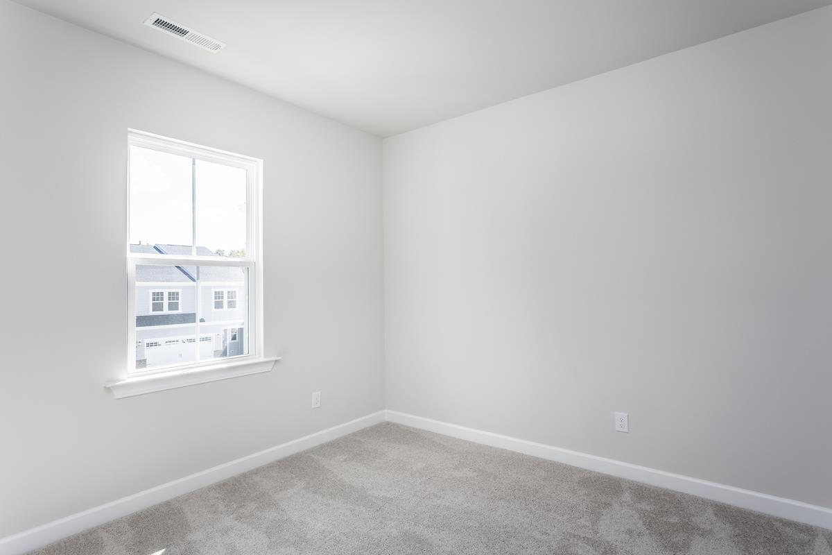 7804 Sofiana Avenue Raleigh, NC 27617 - Photo 18 of 28 an empty room with windows
