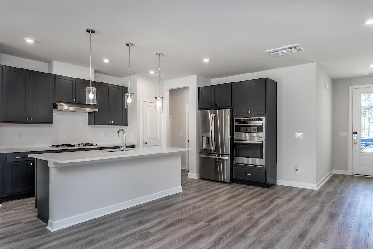 7804 Sofiana Avenue Raleigh, NC 27617 - Photo 5 of 28 a view of kitchen with stainless steel appliances granite countertop a refrigerator and a stove top oven