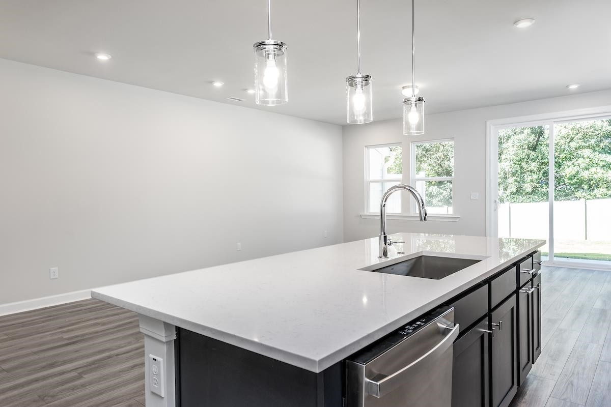 7804 Sofiana Avenue Raleigh, NC 27617 - Photo 7 of 28 a kitchen with a table chairs and window