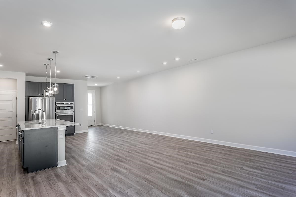 7804 Sofiana Avenue Raleigh, NC 27617 - Photo 10 of 28 an empty room with wooden floor and windows