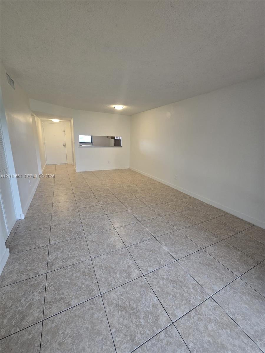 3396 Foxcroft Road, Unit 113 Miramar, FL 33025 - Photo 3 of 17 a view of a livingroom and a walk in closet