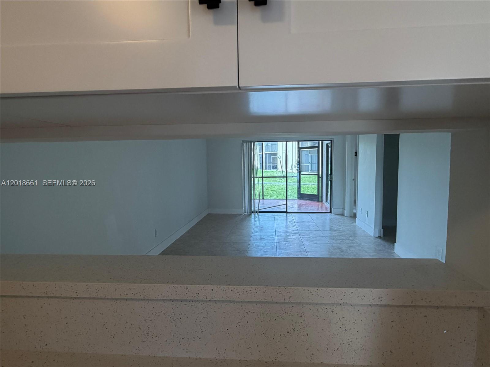3396 Foxcroft Road, Unit 113 Miramar, FL 33025 - Photo 7 of 17 a view of a livingroom with wooden floor and a window