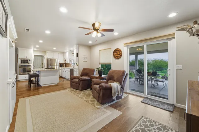 a living room with lots of furniture and a large window