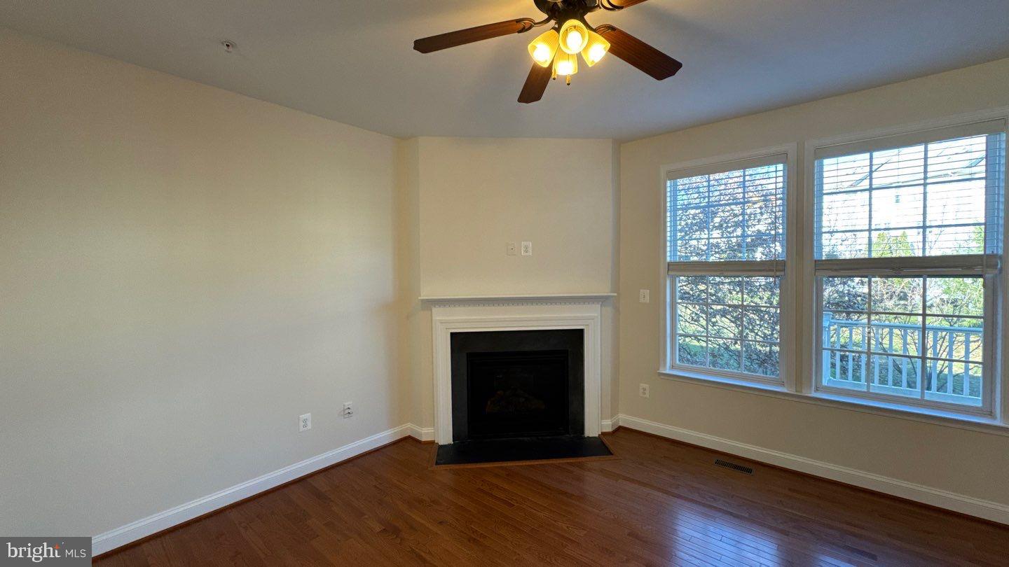9727 June Flowers Way Laurel, MD 20723 - Photo 11 of 30 a view of an empty room with wooden floor and a window