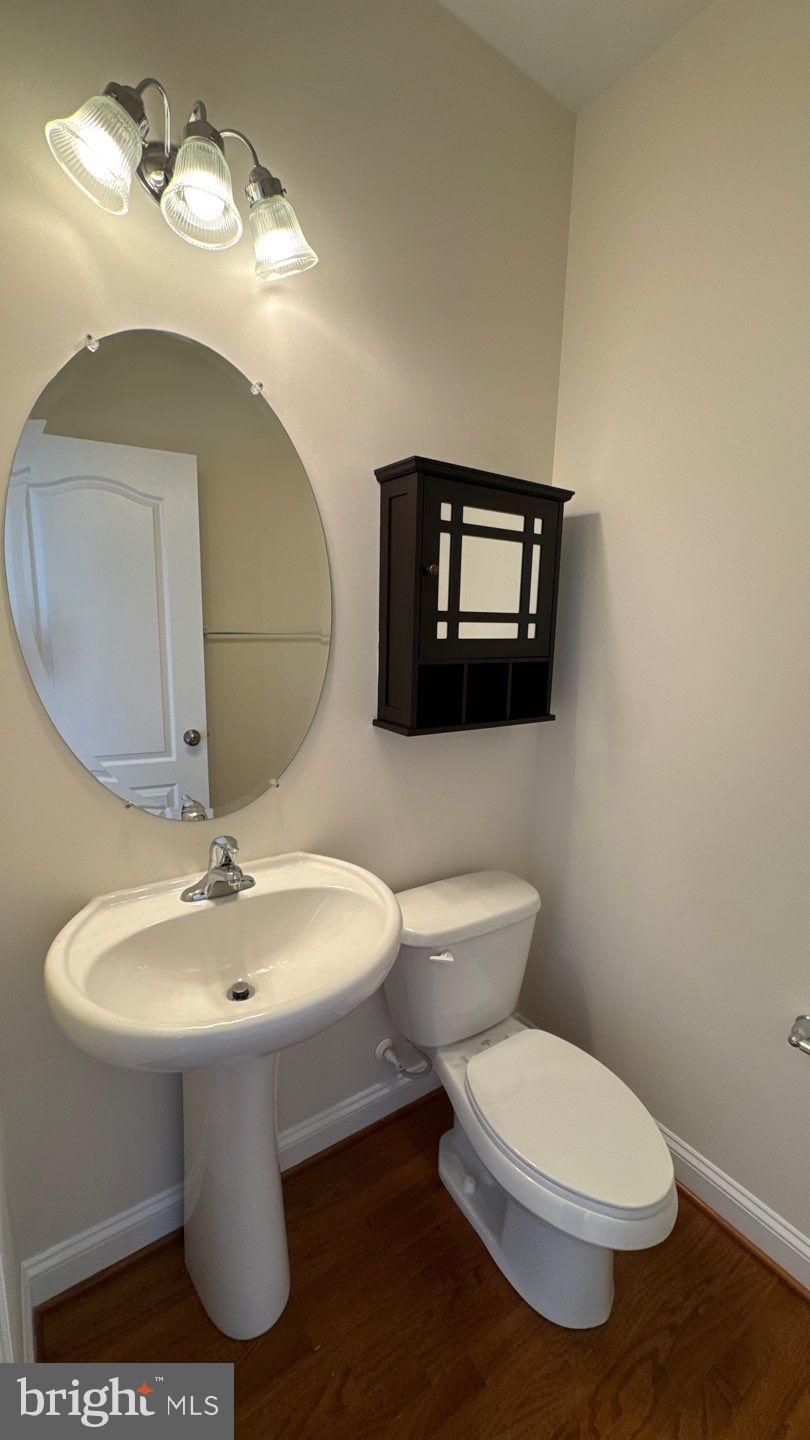 9727 June Flowers Way Laurel, MD 20723 - Photo 14 of 30 a bathroom with a toilet sink and mirror