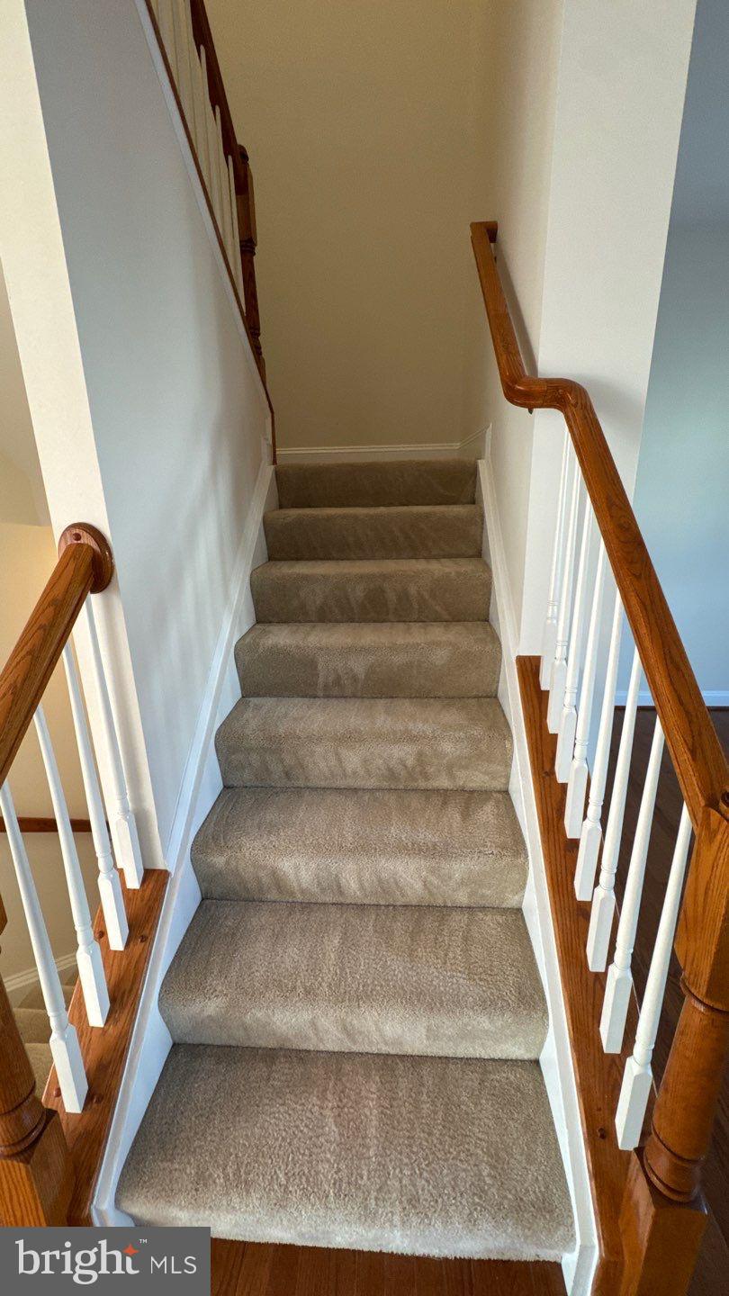 9727 June Flowers Way Laurel, MD 20723 - Photo 15 of 30 a view of staircase with wooden floor and white walls