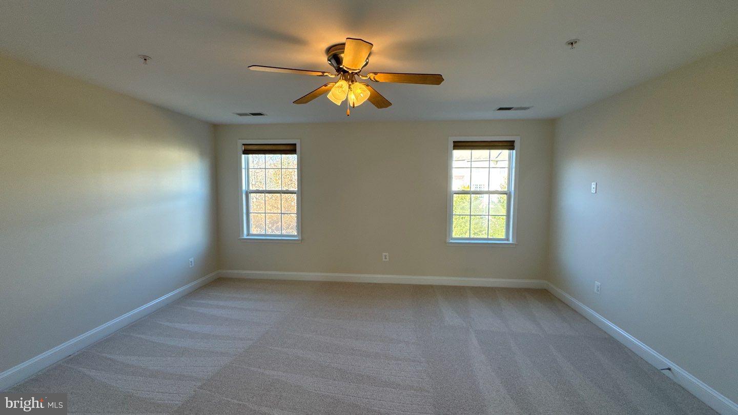 9727 June Flowers Way Laurel, MD 20723 - Photo 16 of 30 a view of room with window and ceiling fan